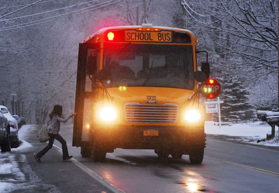 Youth group students boarding a school bus for a church-sponsored trip