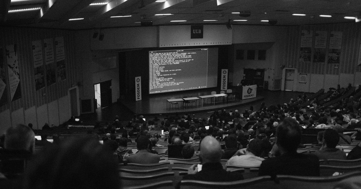 Large auditorium filled with conference audience